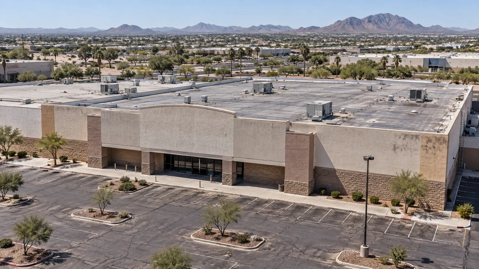 Big-box retail building with an aged flat roof and rooftop units